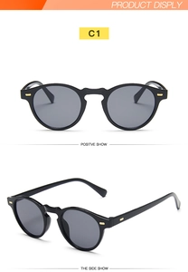Detail view of retro Boston style black round sunglasses with gold decorative metal studs