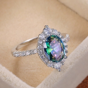 Exquisite four-prong oval rainbow zircon ring for women in a beige velvet jewelry box