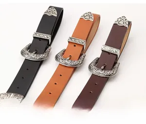 Detail of vintage western belts with ornate silver floral buckles and textured leather