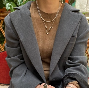 Detail of 925 sterling silver layered necklace with pearl pendant on a model