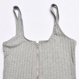 Detail view of grey ribbed knit bodysuit with front zipper and sleeveless design