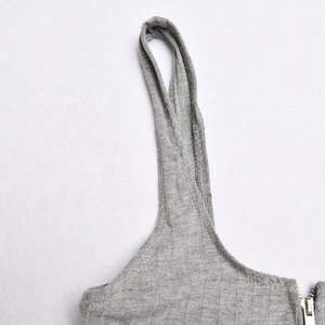 Detail showing grey ribbed knit fabric and sturdy double-stitched seams with a metal zipper