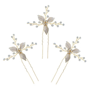 Detailed view of three gold bridal hair pins featuring silver leaves and faux pearls