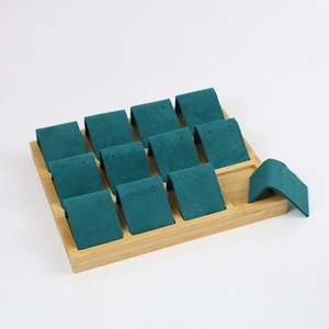 Bamboo jewelry display stand with dark green microfiber pads for earrings and rings