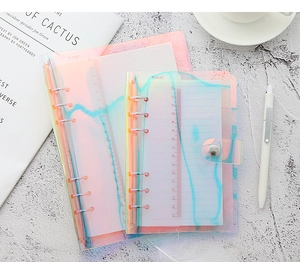 Detail of laser iridescent transparent PVC loose-leaf notebook binder with silver metal rings