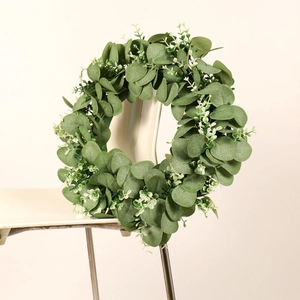 Artificial eucalyptus wreath for front door decor displayed on a neutral chair back