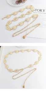 Detail of adjustable gold leaf metal waist chain with delicate rose flower pendant charm