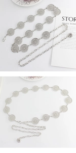 Detailed view of silver metal leaf waist chain with hollow round patterns and rose pendant