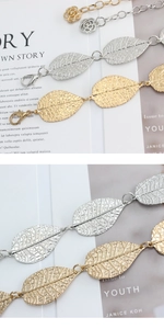 Detail of metal leaf waist chain with rose extender and lobster clasp closure