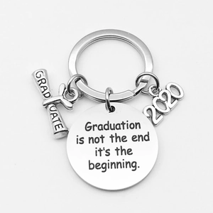 Detailed macro of stainless steel graduation keychain with 2020 charm and engraved tags