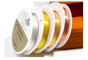 Detail of 0.6mm beadia copper wire rolls in gold and silver for jewelry making