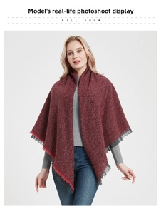 Detail of dark red knit shawl with grey and red fringe tassels for autumn and winter