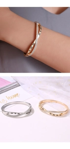 Detail view of gold and silver Roman numeral bracelets with sparkling rhinestones