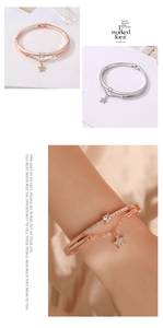 Detail of rose gold and silver layered bracelet featuring star pendant with crystal pave