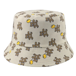 Close-up of cute cartoon brown bear print on beige cotton reversible sun bucket hat