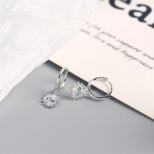 Detailed shot of S925 sterling silver evil eye hoop earrings with blue crystal inlay