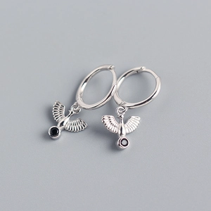 Close-up of silver peace dove hoop earrings featuring a black gemstone charm