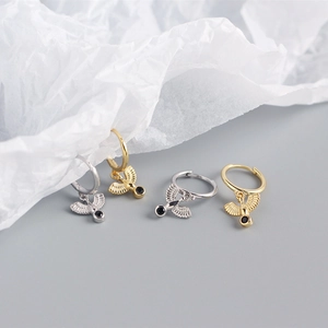 Detailed view of S925 sterling silver flying bird earrings with black gemstone inlays