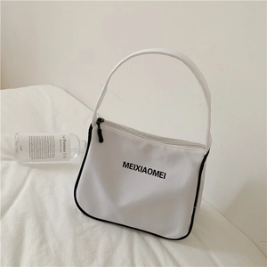 Detail shot of a white nylon underarm bag with black trim and MEIXIAOMEI lettering