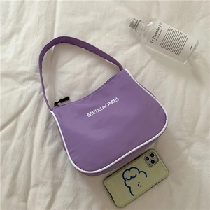Detail of purple nylon shoulder bag with white trim and Meixiaomei logo on fabric