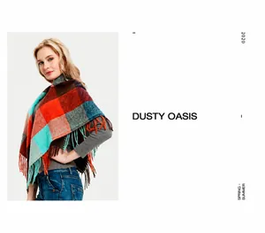 Detail of a large plaid scarf with long tassels featuring blue, orange, and brown check pattern