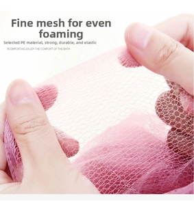 Close-up of soft pink PE mesh bath ball showing dense pores and high elasticity