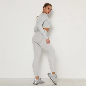Detailed close-up showing the seamless ribbed texture and butt-lifting effect of the grey yoga set