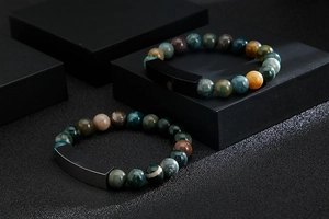 Macro view of multi-color natural stone beads and matte black rectangular bar bracelet