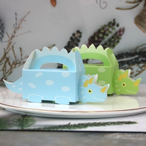 Detail of dinosaur-shaped paper gift boxes in blue and green for kids parties