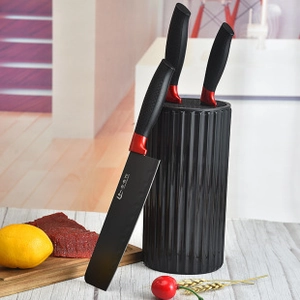 Detailed view of professional stainless steel chef knife set with black cylindrical holder