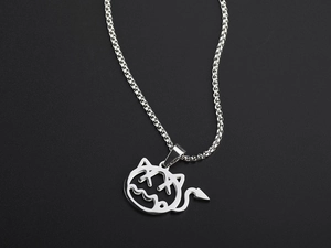 Detail view of silver little devil pendant with horns and tail on a sleek stainless steel chain
