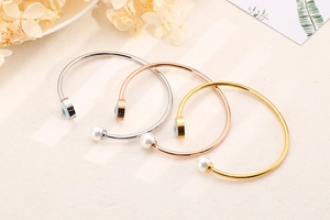 Detailed view of evil eye and pearl bracelets in gold, rose gold and silver finishes