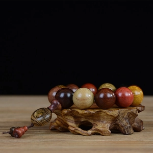 Close-up of 20mm multicolor redwood beads bracelet with gourd and safety buckle charms