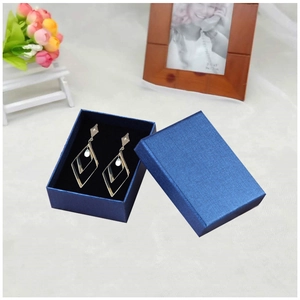 Silver geometric rhombus earrings in a premium textured navy blue jewelry gift box
