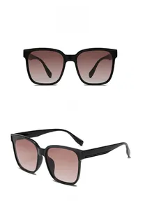 Front and side view of square oversized sunglasses with black frame and gradient tea lenses