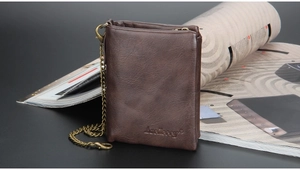 Detail of dark brown leather men's wallet with metal chain and embossed brand logo