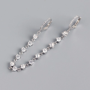 Macro view of silver fringe drop earrings with sparkling round zircon crystals