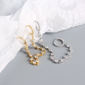 Close-up of S925 sterling silver tassel earrings in gold and silver with zircon stones