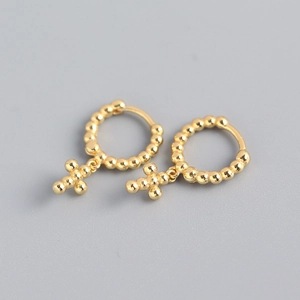 Close-up of gold S925 sterling silver hoop earrings with beads and a cross charm