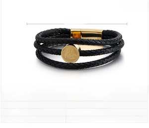 Macro shot of multilayer leather bracelet with steel circular tag and magnetic clasp