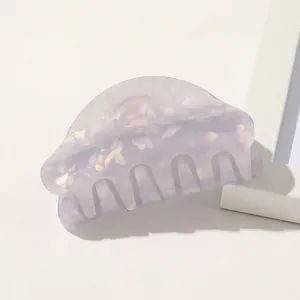 Detail of lavender acetate hair claw with shimmering gold glitter and marble texture