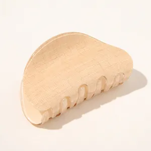 Detailed view of beige large hair claw clip with anti-slip grid fabric texture