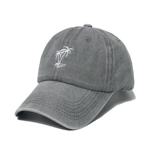 Washed dark gray baseball cap featuring white coconut tree embroidery on white background