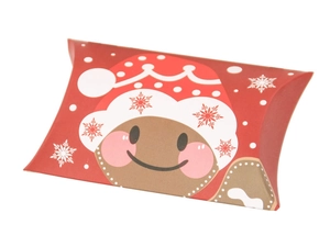 Macro shot of red gingerbread man pattern on festive Christmas pillow candy boxes