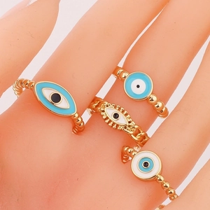 Gold evil eye ring set for women with turquoise enamel and crystal details on fingers