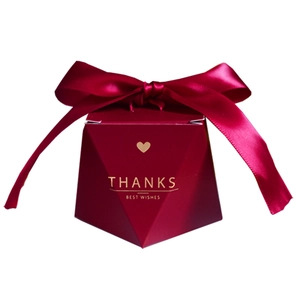 Elegant red diamond shaped gift box with silk ribbon and golden thanks text