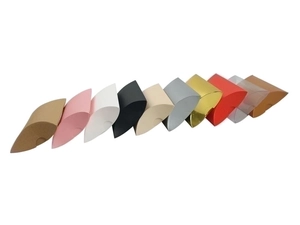 Detailed view of colorful paper and transparent PVC pillow-shaped candy boxes
