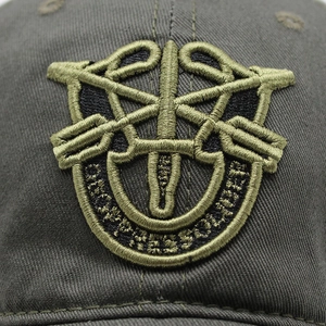 Close-up of olive green tactical baseball cap with detailed De Oppresso Liber embroidery