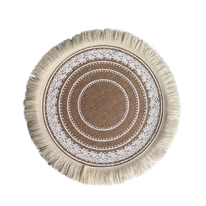 Bohemian round woven placemat with jute texture, white lace floral pattern and fringe edge