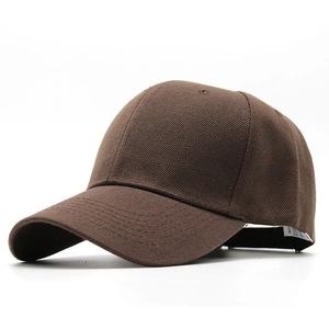 Detail view of the brown cotton twill fabric and curved brim on a solid baseball cap